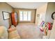 Comfortable living room with carpet flooring, natural light, and neutral colored walls at 7322 Stones River Dr, Indianapolis, IN 46259