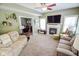 Inviting living room with a fireplace, neutral carpet, and comfortable seating at 7322 Stones River Dr, Indianapolis, IN 46259