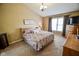 Main bedroom features plush carpet, a ceiling fan, natural light, and vaulted ceiling at 7322 Stones River Dr, Indianapolis, IN 46259
