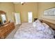Main bedroom featuring plush carpet, natural light, with access to the primary ensuite at 7322 Stones River Dr, Indianapolis, IN 46259