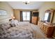 Main bedroom with plush carpet, ceiling fan, natural light, and and dressers at 7322 Stones River Dr, Indianapolis, IN 46259