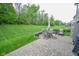 Stone patio featuring an outdoor dining set and a barbecue grill perfect for entertaining, surrounded by a well-kept yard at 7322 Stones River Dr, Indianapolis, IN 46259