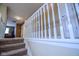 Stairwell with white railing and carpeted steps at 7322 Stones River Dr, Indianapolis, IN 46259