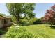 Expansive backyard with mature trees, lush landscaping, and a well-maintained lawn at 7401 Spring Mill Rd, Indianapolis, IN 46260