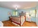 Bright bedroom with hardwood floors, decorative lighting, and a full-size bed at 7401 Spring Mill Rd, Indianapolis, IN 46260