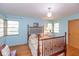 A bright bedroom features hardwood floors, two windows, and a comfortable bed at 7401 Spring Mill Rd, Indianapolis, IN 46260