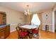 Cozy dining area with a chandelier, wood table, and a charming built-in cabinet at 7401 Spring Mill Rd, Indianapolis, IN 46260