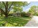 Charming single-story home with stone accents, mature trees, and a well-manicured lawn at 7401 Spring Mill Rd, Indianapolis, IN 46260