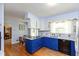 Bright kitchen features blue and white cabinets, granite countertops, and modern appliances at 7401 Spring Mill Rd, Indianapolis, IN 46260