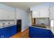 Spacious kitchen with blue cabinets, modern appliances, and a view into the breakfast area at 7401 Spring Mill Rd, Indianapolis, IN 46260