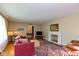 Spacious living room with hardwood floors, a fireplace, and natural light from large windows at 7401 Spring Mill Rd, Indianapolis, IN 46260