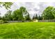 Large grassy back yard features a wood fence and storage shed at 7580 Sherry Ln, Brownsburg, IN 46112