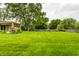Expansive back yard with lawn, mature trees and wood fence at 7580 Sherry Ln, Brownsburg, IN 46112