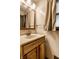 A bathroom features a wooden vanity, sink, mirror, and window at 7580 Sherry Ln, Brownsburg, IN 46112