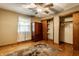 Bedroom with hardwood floors, ceiling fan, rug, closet, and armoire at 7580 Sherry Ln, Brownsburg, IN 46112