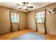 Bedroom with hardwood floors, two windows, and a rug at 7580 Sherry Ln, Brownsburg, IN 46112