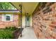 A close up of the brick wall and the front door of a charming home at 7580 Sherry Ln, Brownsburg, IN 46112