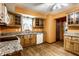 A kitchen featuring custom cabinetry, updated appliances, and luxury wood floors at 7580 Sherry Ln, Brownsburg, IN 46112