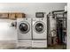 Laundry room with washer, dryer, water heater, and shelving at 7580 Sherry Ln, Brownsburg, IN 46112