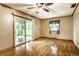 Living room with wood floors, fan and access to the deck at 7580 Sherry Ln, Brownsburg, IN 46112