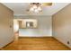 Open-concept living area featuring hardwood floors, neutral paint, and modern ceiling fan at 7580 Sherry Ln, Brownsburg, IN 46112