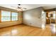 A well lit living room with hardwood floors, a ceiling fan, and a large window at 7580 Sherry Ln, Brownsburg, IN 46112