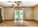 Bright living room featuring hardwood floors and a sliding glass door to a backyard at 7580 Sherry Ln, Brownsburg, IN 46112
