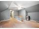 Finished attic space with neutral walls, carpeting, ceiling fan, and stairs to the floor below at 7910 N College Ave, Indianapolis, IN 46240