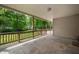 Covered back porch with a view of mature trees at 7910 N College Ave, Indianapolis, IN 46240