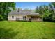 Exterior view of house and backyard with mature trees at 7910 N College Ave, Indianapolis, IN 46240