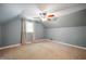 Attic Bedroom featuring a ceiling fan, carpeting, and a window letting in natural light at 7910 N College Ave, Indianapolis, IN 46240