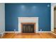 Close-up view of fireplace with traditional white mantel and brick surround at 7910 N College Ave, Indianapolis, IN 46240