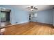 Sunlit living room with hardwood floors and access to other rooms at 7910 N College Ave, Indianapolis, IN 46240
