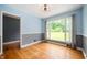 Dining room with large window, offering lots of light and hardwood floors at 7910 N College Ave, Indianapolis, IN 46240