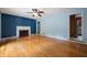 Spacious living room boasting hardwood floors and a traditional fireplace with decorative mantle at 7910 N College Ave, Indianapolis, IN 46240