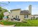 Well-maintained backyard featuring a patio with outdoor seating and a grass lawn, perfect for relaxation and entertaining at 8958 Wooster Ct, Fishers, IN 46038