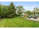 Spacious backyard with lush green lawn, playset, and outdoor seating area at 8958 Wooster Ct, Fishers, IN 46038