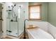 Modern bathroom with walk-in shower, soaking tub, and elegant fixtures at 8958 Wooster Ct, Fishers, IN 46038