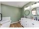 Stylish bathroom features double vanity, modern fixtures, and soaking tub at 8958 Wooster Ct, Fishers, IN 46038