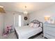 ' bedroom with a black metal frame bed, chandelier, and dresser at 8958 Wooster Ct, Fishers, IN 46038