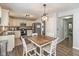 Eat-in kitchen featuring white cabinets, stainless steel appliances, and a rustic dining table at 8958 Wooster Ct, Fishers, IN 46038