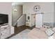 Open living room with vaulted ceiling, statement clock, barn door, and neutral décor at 8958 Wooster Ct, Fishers, IN 46038