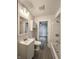 Bathroom with white vanity, toilet, tub, and shower featuring wood-look flooring at 946 N Somerset Ave, Indianapolis, IN 46222