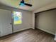 Bedroom with light walls and flooring, a ceiling fan, closet, and bright window at 946 N Somerset Ave, Indianapolis, IN 46222