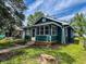 This lovely home features nice landscaping and a charming front porch at 946 N Somerset Ave, Indianapolis, IN 46222