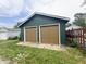 This two-car garage has two brown garage doors and green siding at 946 N Somerset Ave, Indianapolis, IN 46222