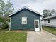 This green garage features one window and a white door at 946 N Somerset Ave, Indianapolis, IN 46222