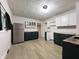 Updated kitchen featuring dark green cabinets, butcher block countertops, and stainless steel appliances at 946 N Somerset Ave, Indianapolis, IN 46222
