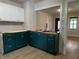 Modern kitchen with dark green cabinets, butcher block countertops, and stainless steel sink at 946 N Somerset Ave, Indianapolis, IN 46222