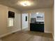 Open-concept living room featuring new wood flooring and an open view into the kitchen at 946 N Somerset Ave, Indianapolis, IN 46222